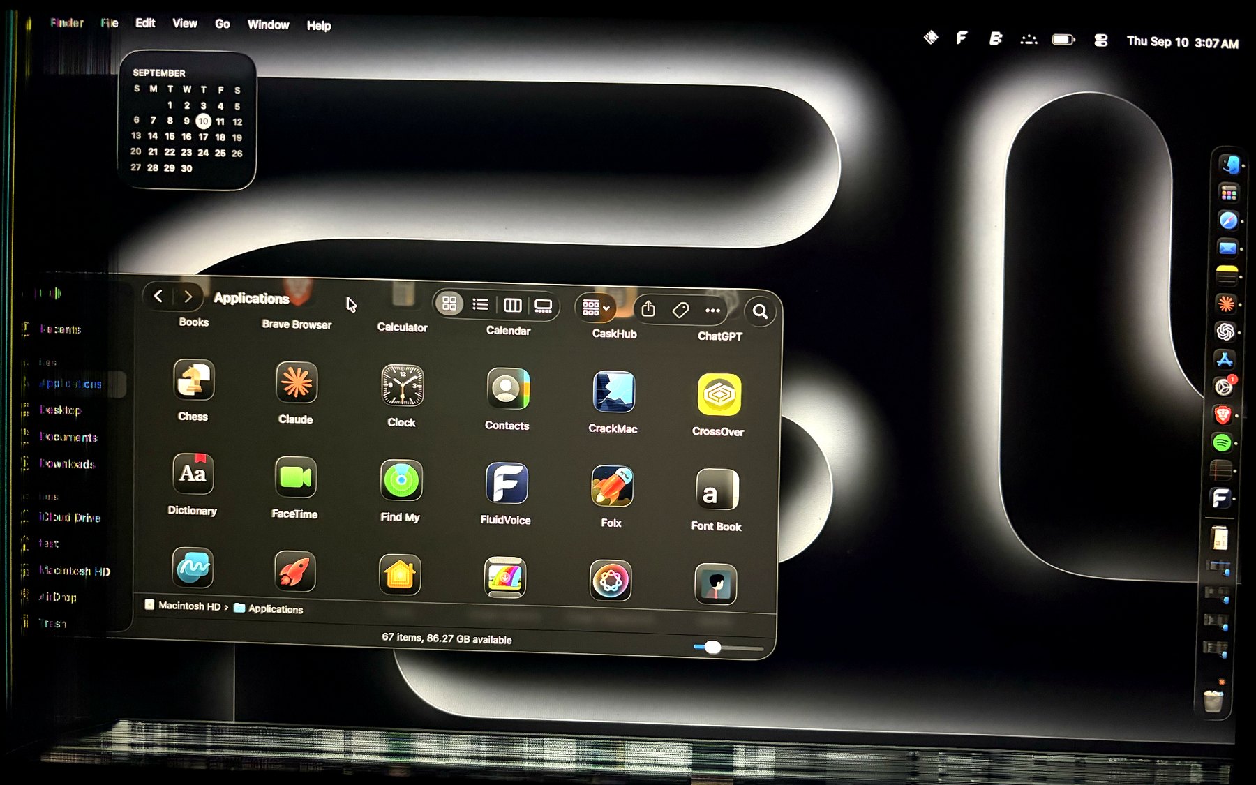 A MacBook Air with a dead strip down the left edge of the display; a Finder window runs off into it and its sidebar is unreadable.